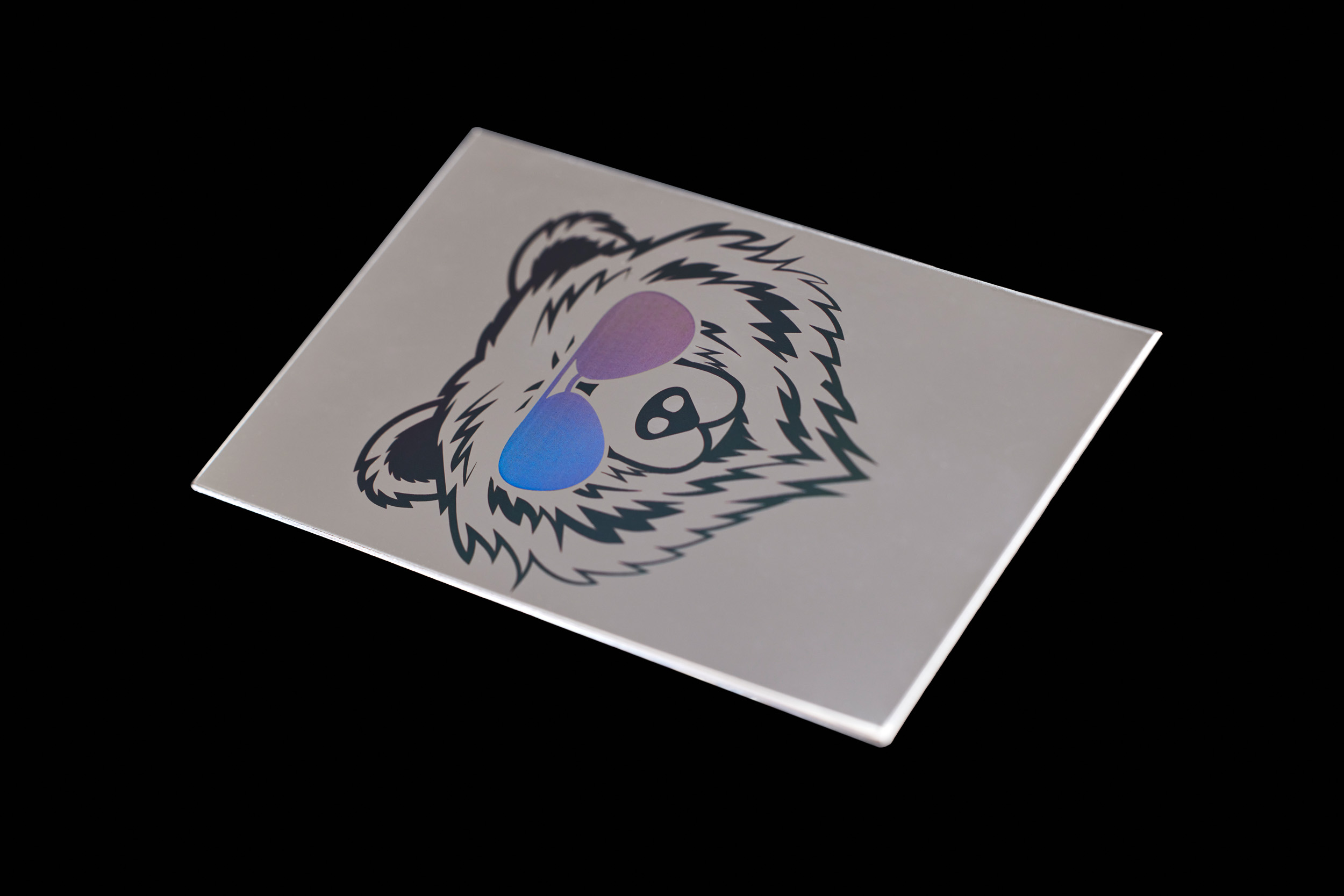 A cool bear with holographic sunglasses laser marked on a stainless steel plate.  