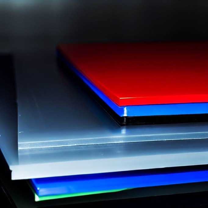 A couple of stacked colorful plastic sheets as material for laser marking.